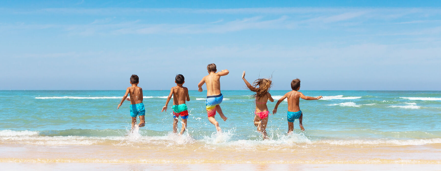 Kids playing in the ocean waves